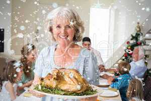 Composite image of happy grandmother with christmas meal