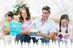 Composite image of family opening christmas gifts