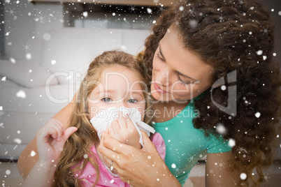 Composite image of mother helping her daughter blow her nose