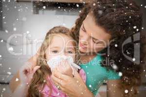 Composite image of mother helping her daughter blow her nose