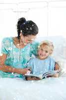 Composite image of girl on a hospital bed reading with her mothe