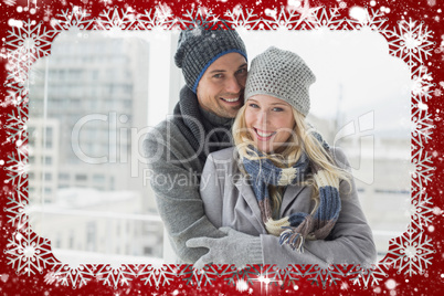 Cute couple in warm clothing smiling at camera