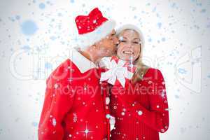 Festive couple smiling and holding gift