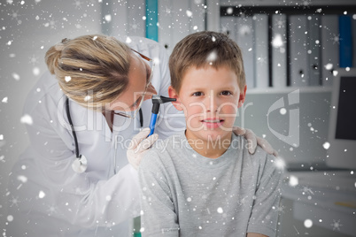 Boy being examined by doctor with otoscope