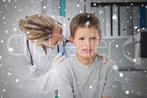 Boy being examined by doctor with otoscope