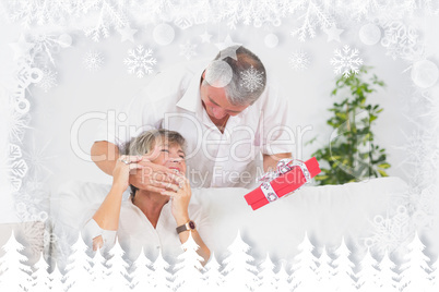 Composite image of old man hiding eyes his wife to give a gift