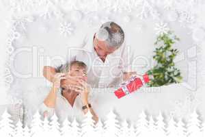 Composite image of old man hiding eyes his wife to give a gift