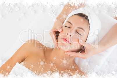 Attractive woman receiving facial massage at spa center