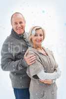 Composite image of happy mature couple in winter clothes