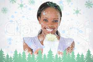 Close up of woman holding a present against a white background