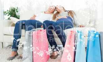 Composite image of a pair of sisters exhausted after shopping