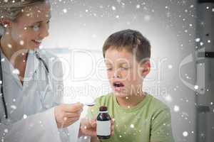 Doctor giving little boy cough syrup