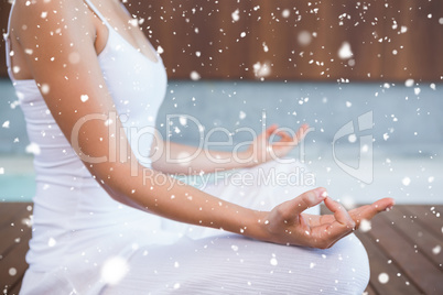 Peaceful woman in white sitting in lotus pose