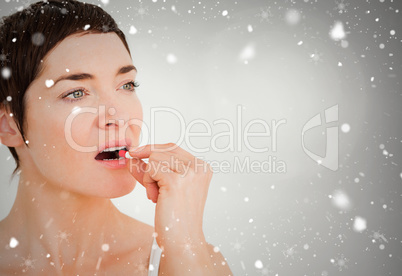 Composite image of close up of a woman taking a pill