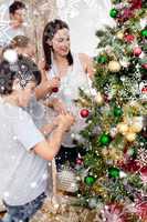 Happy children and parents decorating a christmas tree