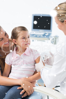 Composite image of girl receiving injection by pediatrician