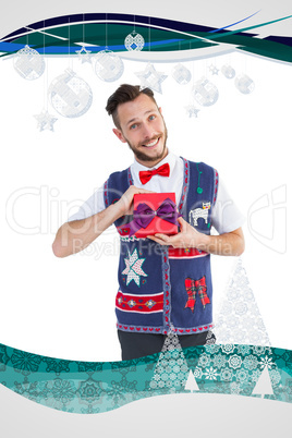 Composite image of geeky hipster offering christmas gift