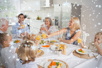 Composite image of family raising their glasses together
