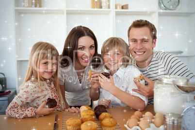 Cute children eating muffins with their parents