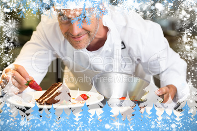 Smiling male pastry chef decorating dessert in kitchen