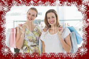 Happy women with shopping bags in clothes store