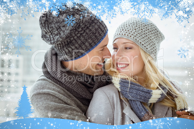 Cute couple in warm clothing smiling at each other