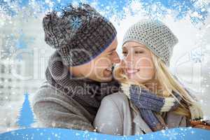 Cute couple in warm clothing smiling at each other