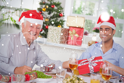 Composite image of family swapping christmas presents