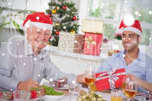 Composite image of family swapping christmas presents