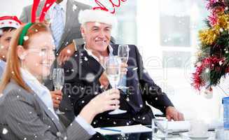 Composite image of businessman team celebrating christmas