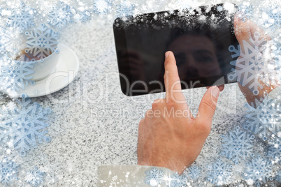 Businessman using small tablet at table