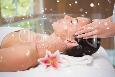 Attractive woman receiving head massage at spa center