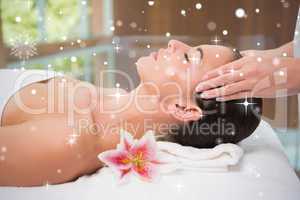 Attractive woman receiving head massage at spa center