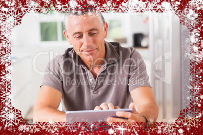 Composite image of happy man using tablet