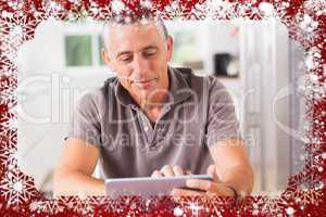 Composite image of happy man using tablet