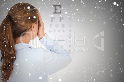 Composite image of brunette woman making an eye test