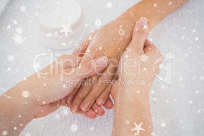 Composite image of hands applying cream