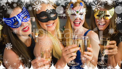 Composite image of smiling friends holding champagne glasses wea