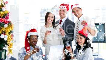 Composite image of smiling business team drinking champagne to c