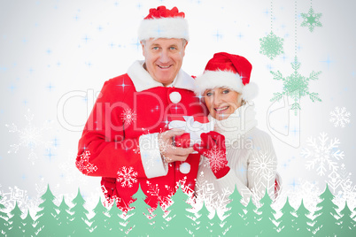 Festive couple smiling and holding gift