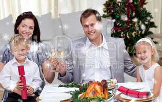 Parents toasting with wine in christmas dinner