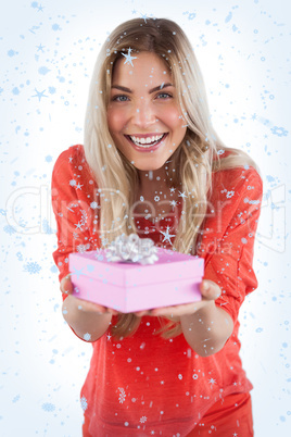 Composite image of young woman offering gift