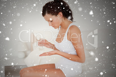 Composite image of sick woman taking pills