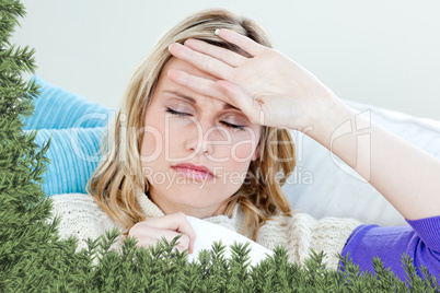 Sick woman with headache lying on the sofa in the livingroom