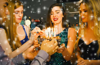 Composite image of happy friends preparing birthday cake