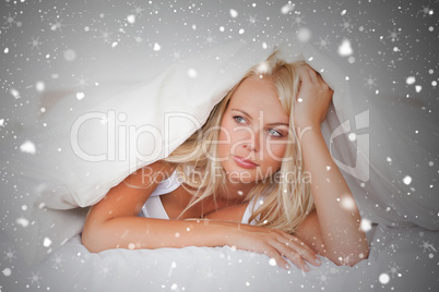 Composite image of woman under a duvet