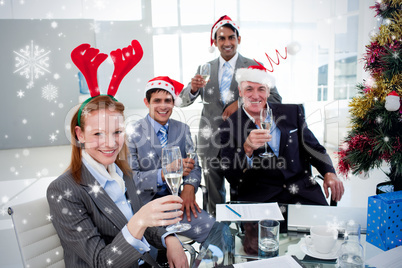 Business team toasting with champagne at a christmas party