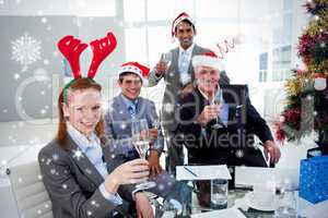 Business team toasting with champagne at a christmas party