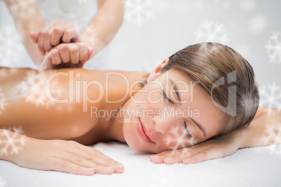 Attractive woman receiving back massage at spa center