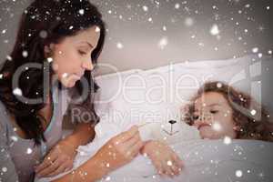 Composite image of mother taking her daughters temperature